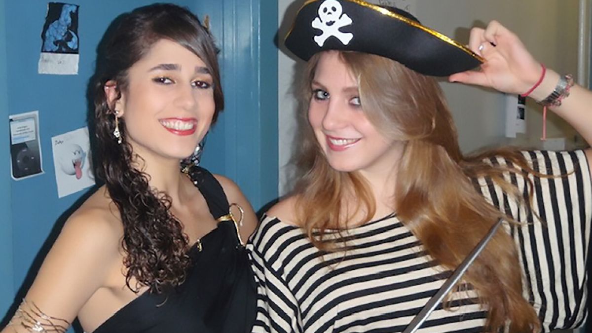 Two students dressed as pirates pose for the camera. 